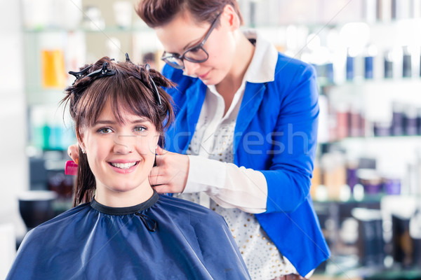 Hairdresser styling woman hair in shop Stock photo © Kzenon