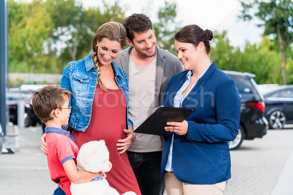 Car dealer advising family on buying auto Stock photo © Kzenon