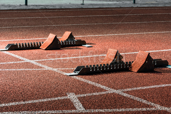 Starrting blocks at cindertrack of athletics stadium Stock photo © Kzenon