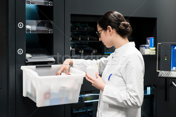 Stock photo: Pharmacist choosing the best medicines during work in drugstore 