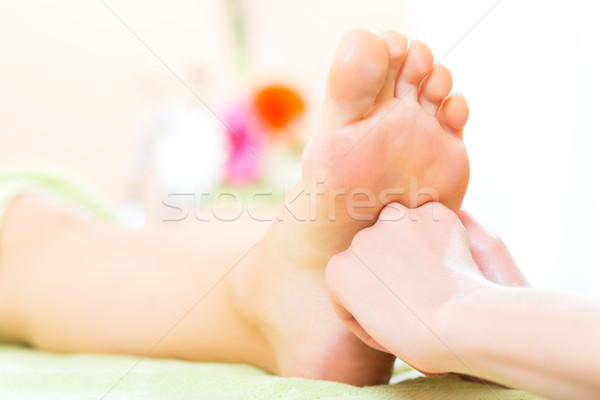 Woman in nail salon receiving foot massage Stock photo © Kzenon