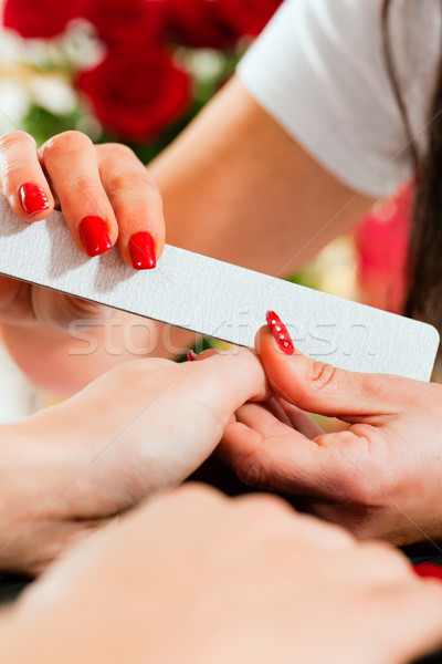 Stock photo: Woman in nail salon receiving manicure