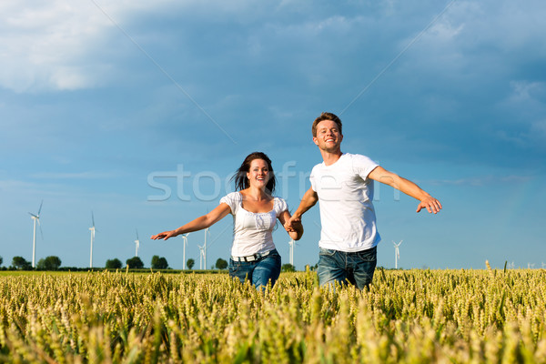 Happy couple running over grainfield Stock photo © Kzenon
