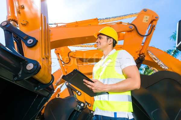 Asian engineer controlling shovel excavator  Stock photo © Kzenon