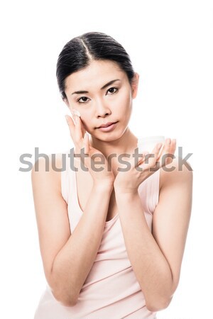 Woman applying facial moisturizer cream for sensitive skin Stock photo © Kzenon