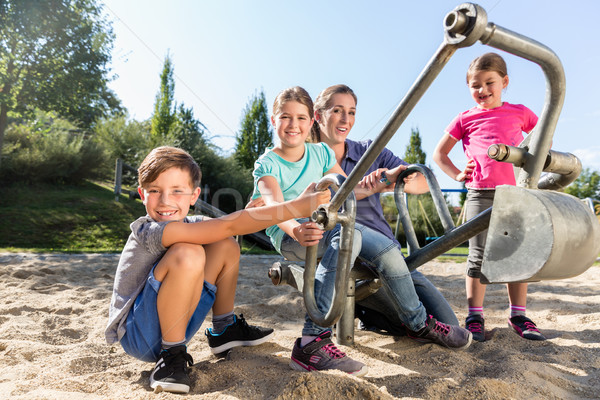 Mother and kids in sandbox playing with digger  Stock photo © Kzenon