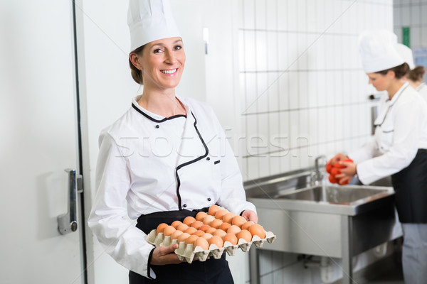 Chef in canteen kitchen taking eggs out of cold store  Stock photo © Kzenon