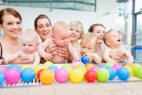 Group picture of mothers and babies at infant swimming class Stock photo © Kzenon