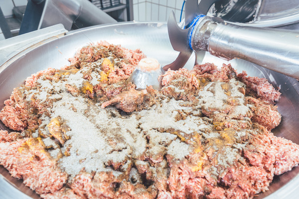 Minced meat being prepared in grinder of butchery Stock photo © Kzenon