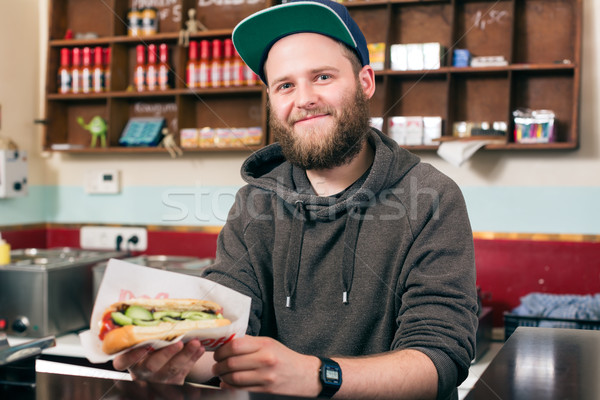 salesman with hotdog in fast food snack bar Stock photo © Kzenon