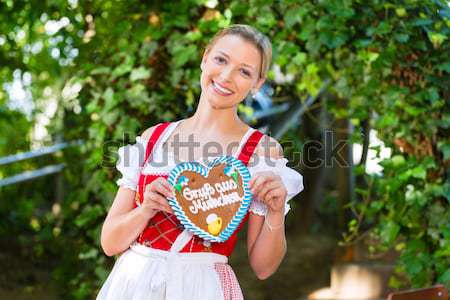 Woman with gingerbread hart in Bavaria beergarden Stock photo © Kzenon