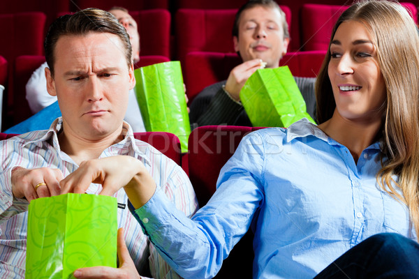 Stock photo: Couple in cinema with popcorn