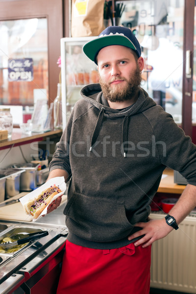 Stock photo: salesman making hotdog in fast food snack bar