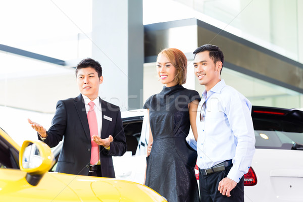 Asian couple buying car in dealership Stock photo © Kzenon