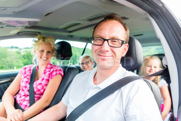 Family driving in car with seat belt fastened Stock photo © Kzenon