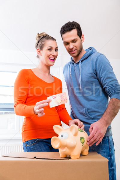 Couple saving money by moving house Stock photo © Kzenon
