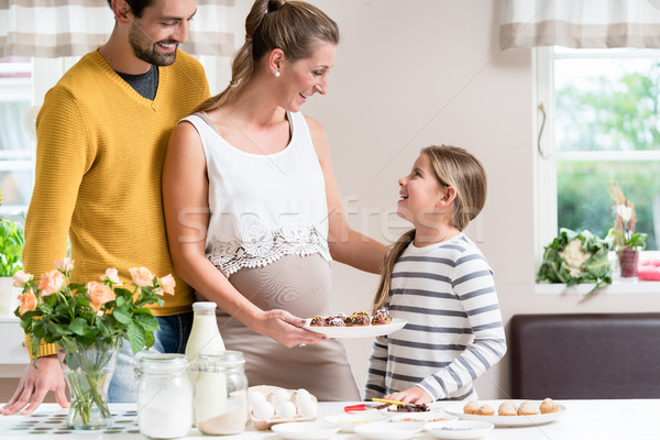 Family with pregnant mother baking together in kitchen Stock photo © Kzenon