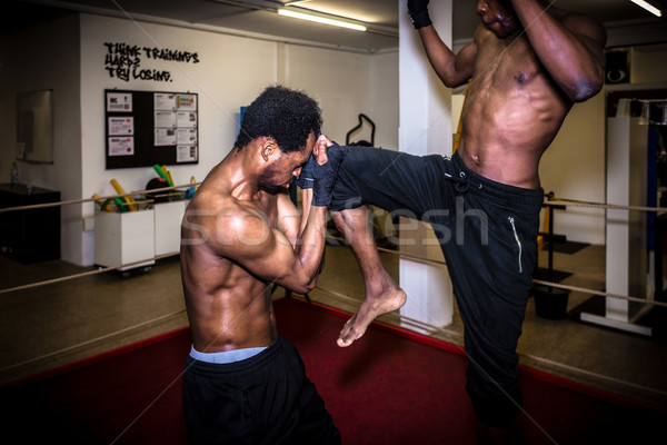 Agile fighter in defensive stance protecting his face from hit Stock photo © Kzenon
