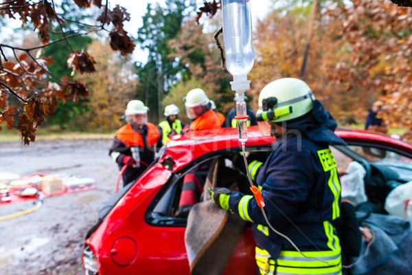 Accident - Fire brigade rescues Victim of a car crash Stock photo © Kzenon