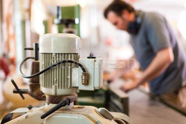 Carpenter with electric cutter Stock photo © Kzenon