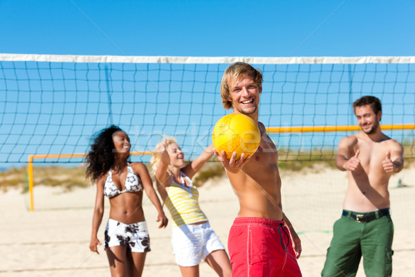 Amici giocare spiaggia pallavolo gruppo donne Foto d'archivio © Kzenon