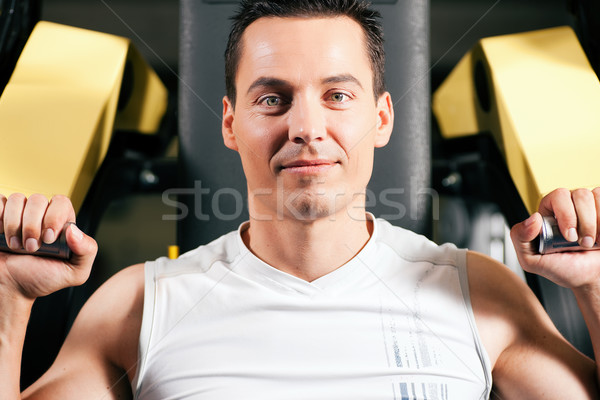 Man exercising and training in gym Stock photo © Kzenon