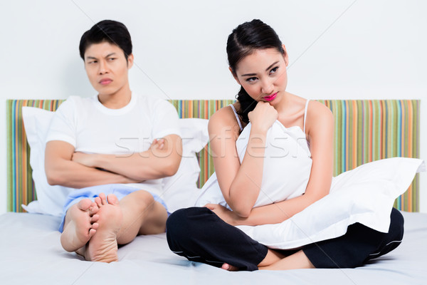 Alienated Chinese couple, woman is rejecting her man Stock photo © Kzenon