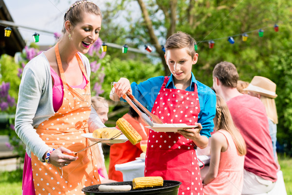 [[stock_photo]]: Mère · fils · griller · viande · jardin · barbecue