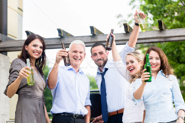 Office colleagues drinking beer after work Stock photo © Kzenon