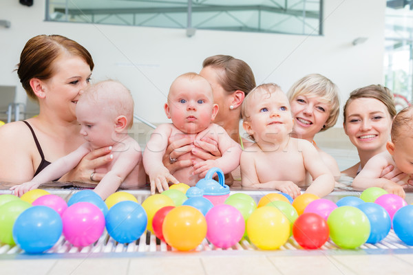 Group picture of mothers and babies at infant swimming class Stock photo © Kzenon