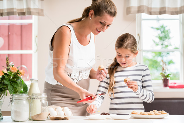 Pregnant mum and her little daughter baking together Stock photo © Kzenon