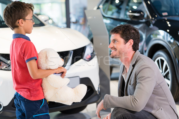 Father with son in car dealer showroom buying auto Stock photo © Kzenon