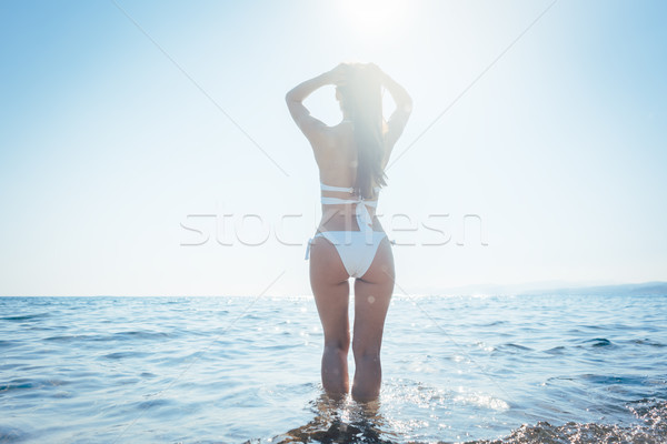 Woman entering the sea in her summer vacation Stock photo © Kzenon