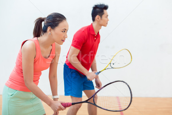 Competitive Chinese woman holding the racquet during a squash game Stock photo © Kzenon