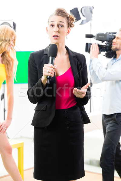 Reporter moderating an interview on film set Stock photo © Kzenon