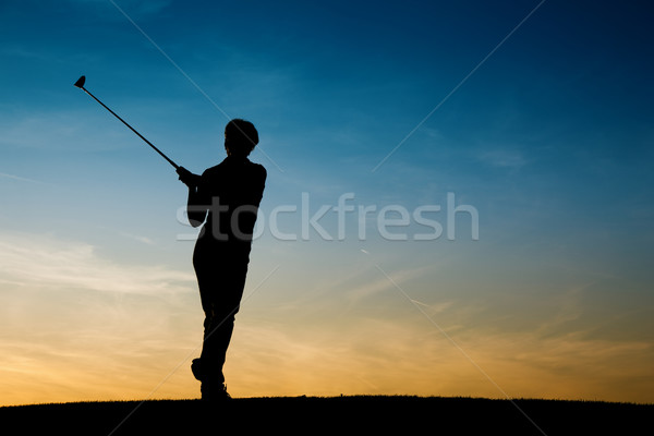 Senior female golf player at sunset Stock photo © Kzenon