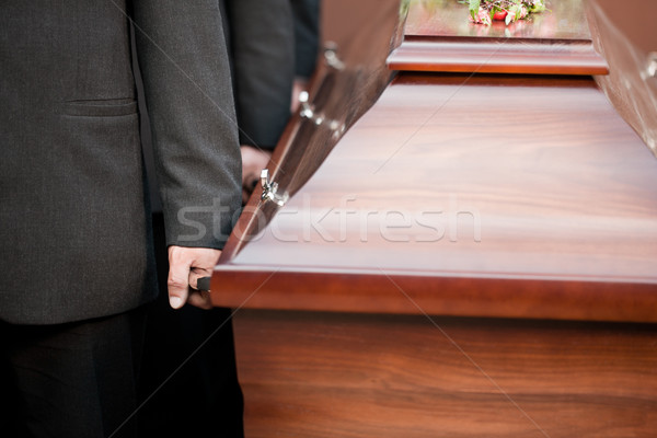 coffin bearer carrying casket at funeral Stock photo © Kzenon