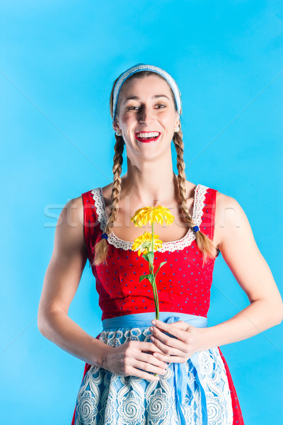 Woman in dirndl dress holding flowers Stock photo © Kzenon