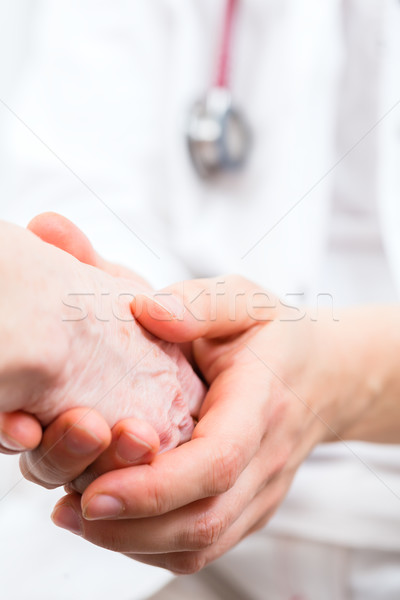 Doctor consoling senior patient practice  Stock photo © Kzenon