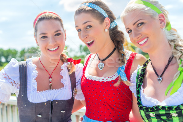 Friends visiting Bavarian fair having fun Stock photo © Kzenon