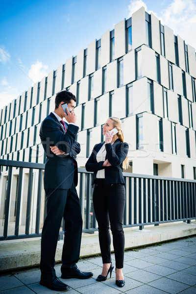 Business people working outdoors in city Stock photo © Kzenon