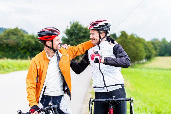 Bicyclists embrace each other in finish celebrating Stock photo © Kzenon