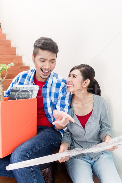 Asian couple with ground plot planning arrangement of new apartm Stock photo © Kzenon