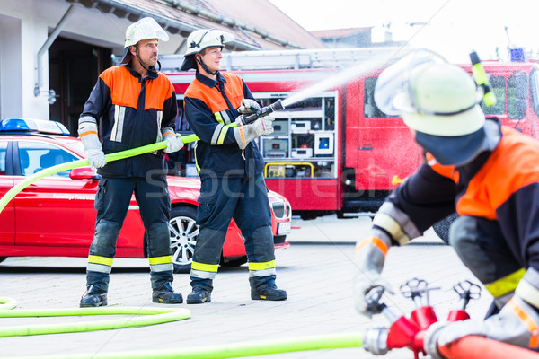 Fire fighter connecting hoses  Stock photo © Kzenon