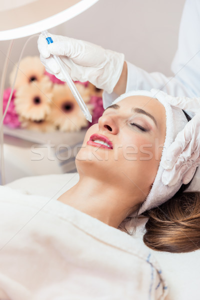 Beautiful woman relaxing during non-invasive facial treatment fo Stock photo © Kzenon