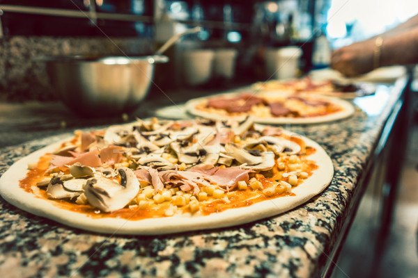Stock photo: Close-up of unbaked pizza dough topped with mushrooms and prosciutto