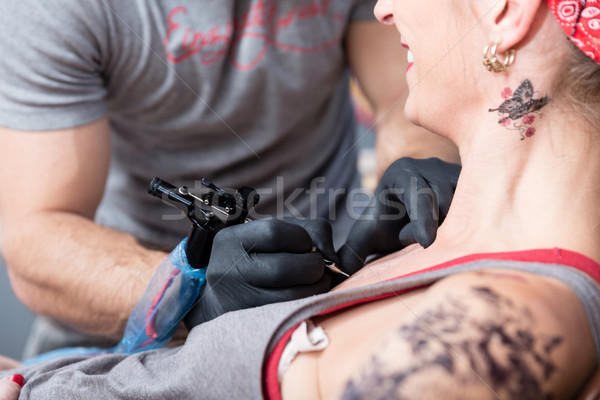 Skilled artist making the contour of a new tattoo on the skin of a client Stock photo © Kzenon