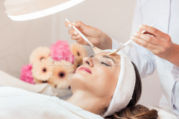 Beautiful woman during anti-aging facial massage in a modern center Stock photo © Kzenon