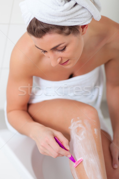 Young woman doing Hair removal at legs Stock photo © Kzenon