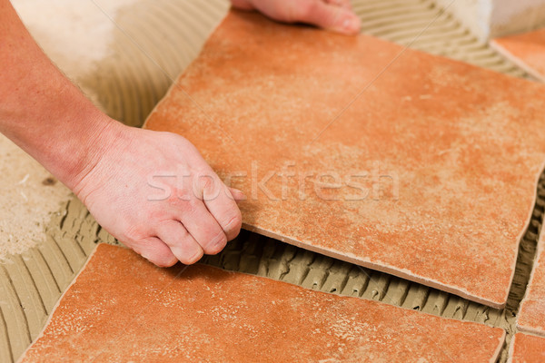 Tiler tiling tiles on the floor Stock photo © Kzenon